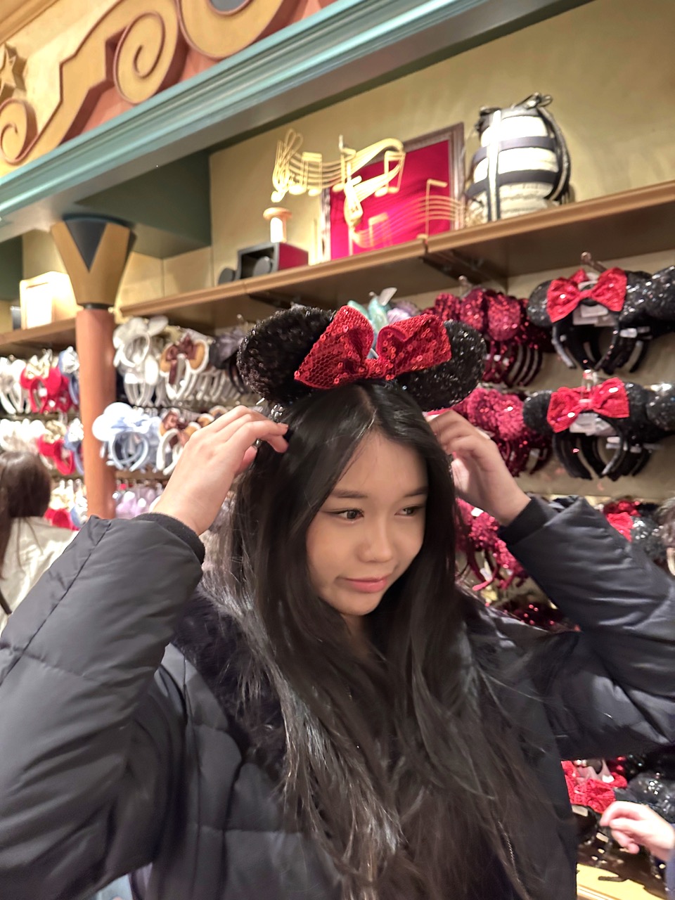girl trying out mickey mouse headband
